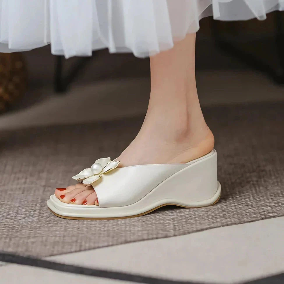 Elegant pearl flower wedge sandals in beige colour, featuring a thick, cushioned platform and adjustable straps for a comfortable fit.