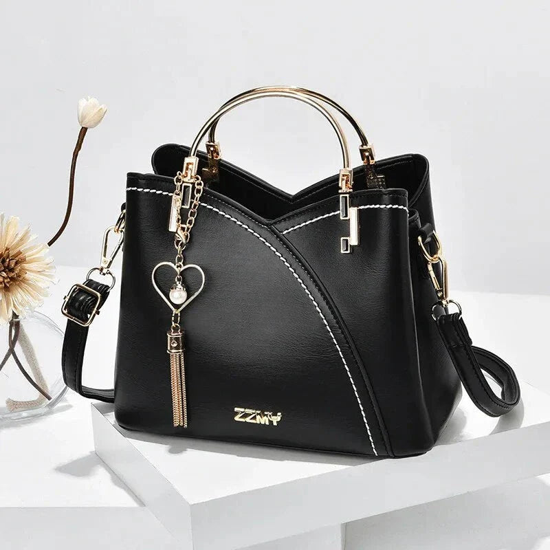 Sophisticated navy blue PU leather bucket crossbody bag with elegant patchwork design and adjustable strap