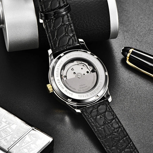 A sophisticated automatic mechanical watch with a gold/white or gold/black face, stainless steel case, and genuine leather strap