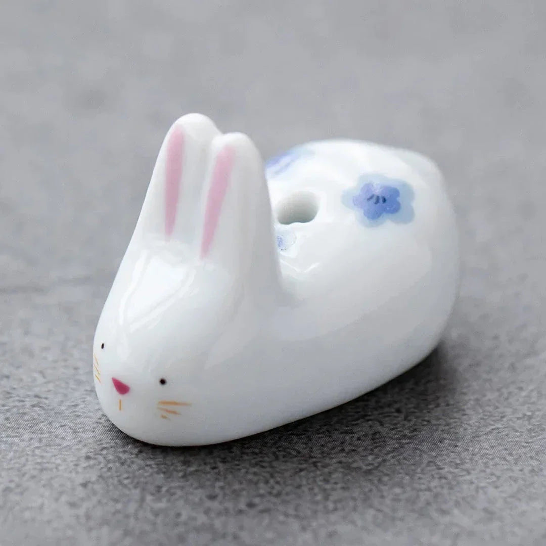 Charming Japanese-style ceramic incense holder with a playful rabbit and kitten design, perfect for creating a relaxing atmosphere in any room.