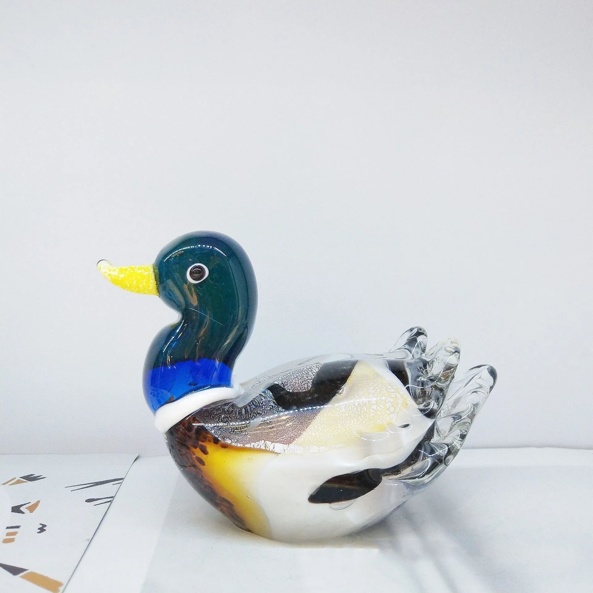 Handcrafted glass ornament in the shape of a Mandarin duck with vibrant colours and intricate details
