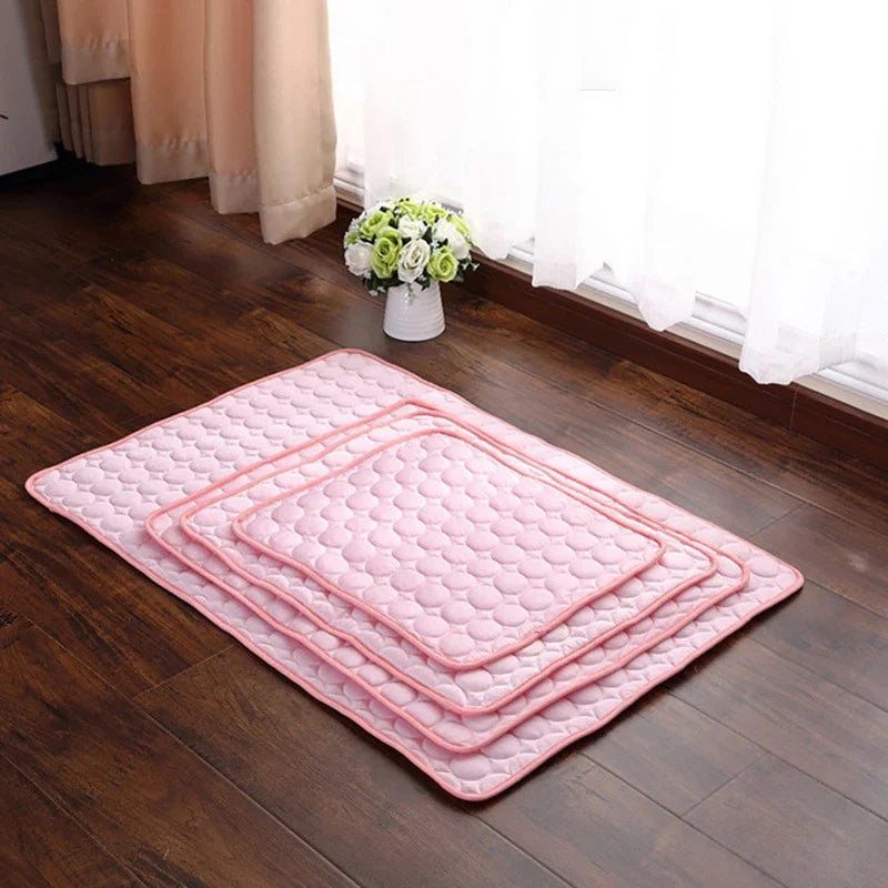 A stylish pet cooling pad featuring a blue ice silk surface and a breathable mesh backing, designed to keep pets cool and comfortable during hot summer days.