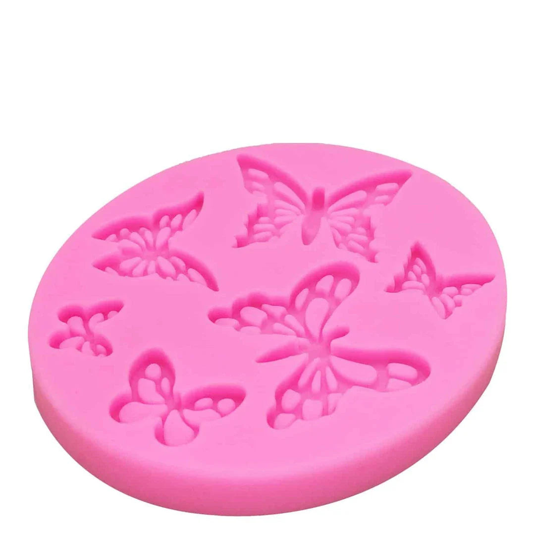 A pink butterfly-shaped silicone fondant mould for creating detailed and intricate fondant decorations