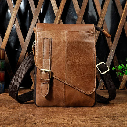 Premium cowhide leather one-shoulder crossbody bag in light grey colour with adjustable strap and zipper pocket