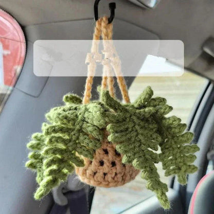 Charming knitted car plant decor with hanging white rope and green and white colour scheme