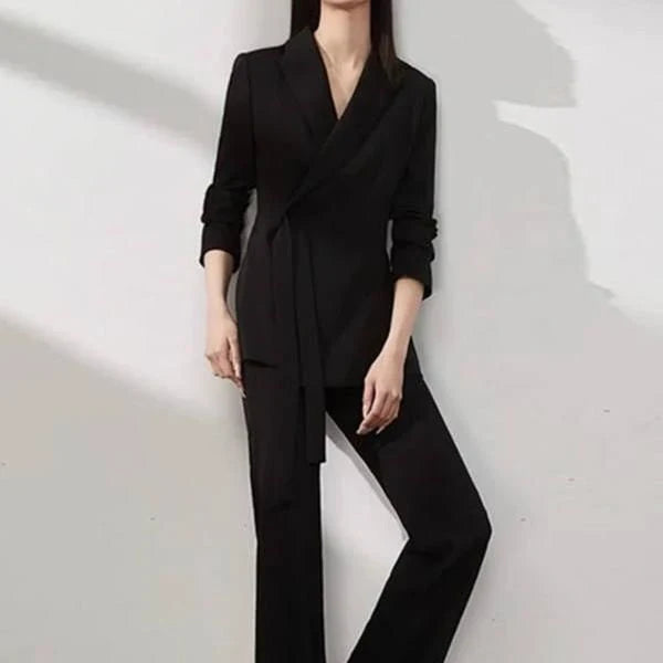 A two-piece vintage-inspired office suit with a long-sleeve blazer and high-waisted trousers, designed for the modern professional woman.
