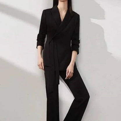 A two-piece vintage-inspired office suit with a long-sleeve blazer and high-waisted trousers, designed for the modern professional woman.