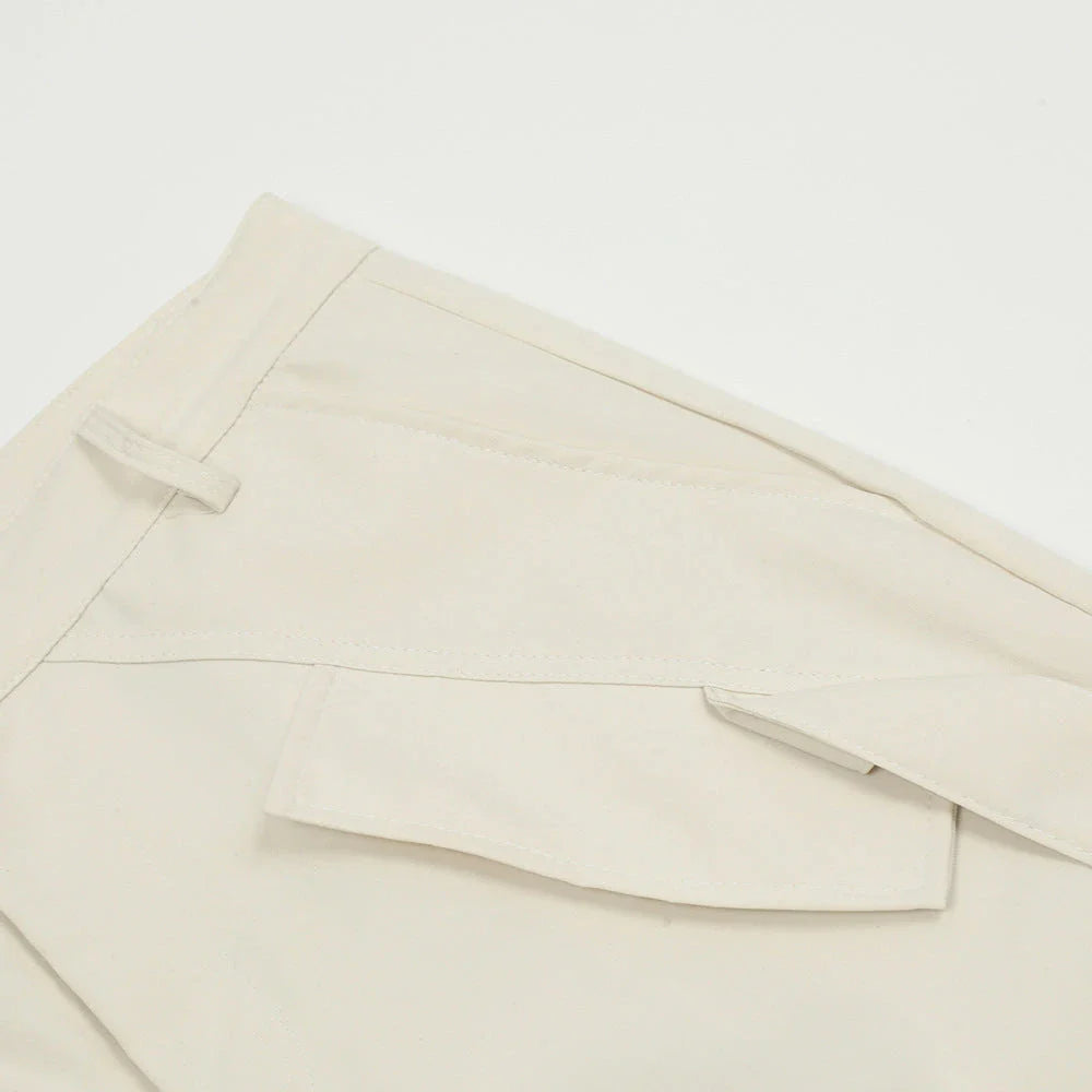 Stylish black pleated overalls with ribbon pockets, a versatile and refined menswear piece.