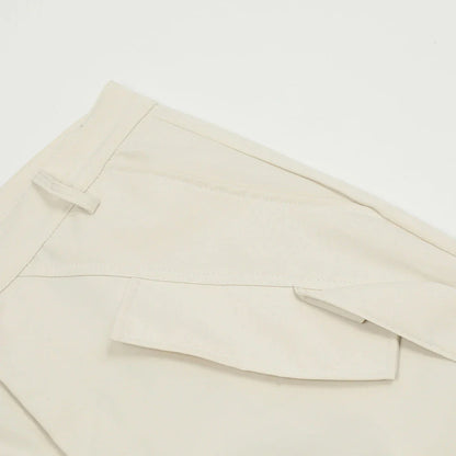 Stylish black pleated overalls with ribbon pockets, a versatile and refined menswear piece.
