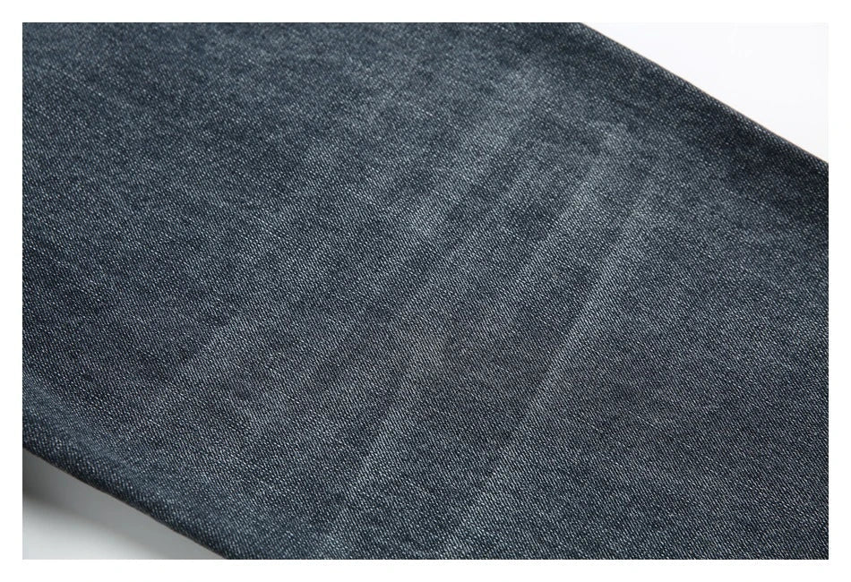 A pair of stylish retro-inspired Japanese jeans in black and grey, featuring a mid-rise waist and straight leg silhouette for a flattering, comfortable fit.