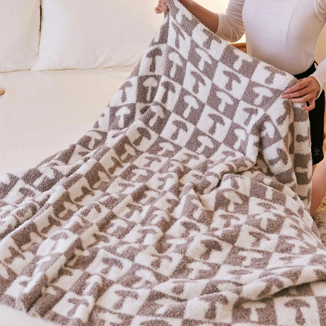 Cosy two-tone checkerboard plaid knitted throw blanket in various colours, including red, blue, grey, and purple