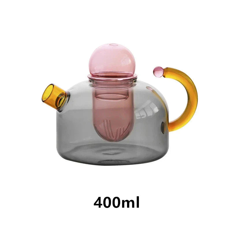 Elegant colourful glass teapot and teacup set with vibrant contrasting colours, perfect for tea and coffee enjoyment