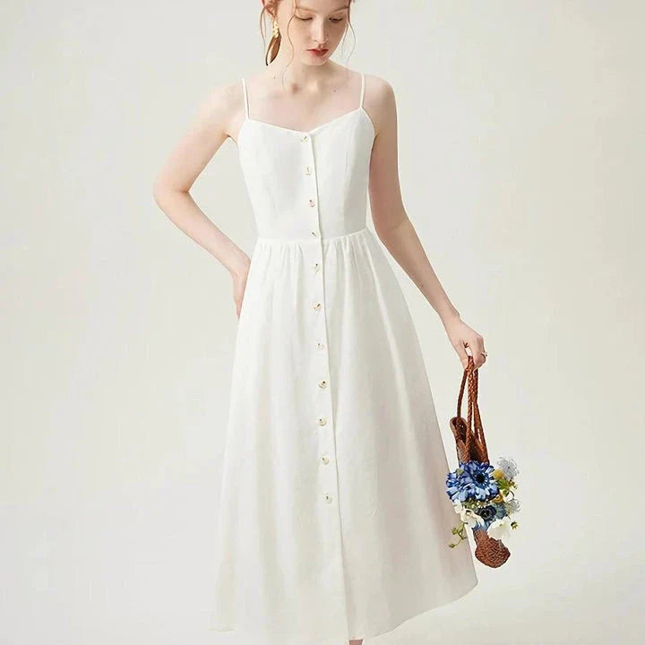 Elegant cotton and linen suspender dress with square collar neckline, A-line silhouette, and mid-calf length for a sophisticated and comfortable summer look.