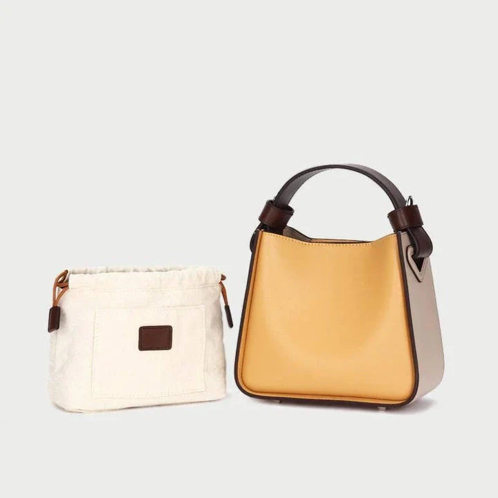 A stylish microfibre leather tote bag with a chic bucket shape and ruched detailing, perfect for the modern British woman.