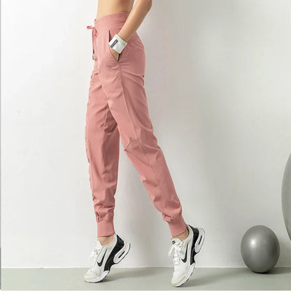 Premium women's sports trousers with drawstring waist and pockets, made of high-quality nylon fabric for comfort and versatility.