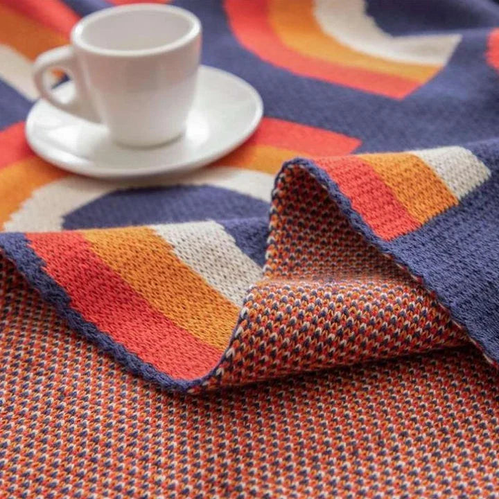 Cosy and vibrant 100% cotton knit throw blanket with a colourful rainbow pattern
