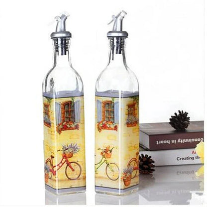 Ethnic-inspired glass bottles with handpainted floral designs, offering stylish storage for sauces, oils, and spices