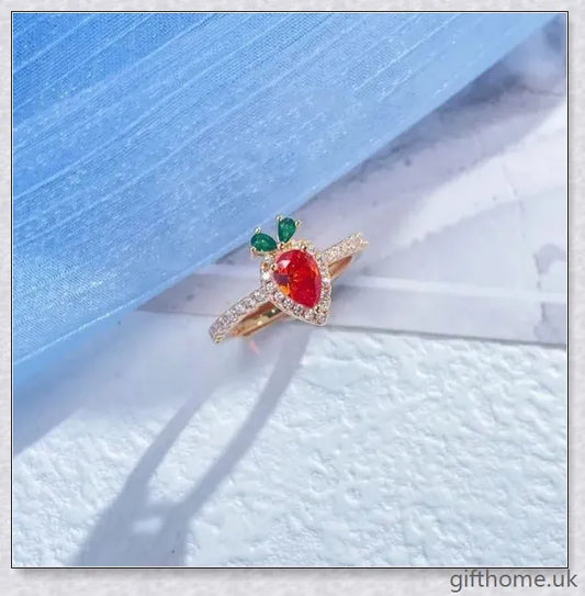 A close-up image of a charming copper ring with a carrot-shaped design and delicate micro-inlaid detailing.