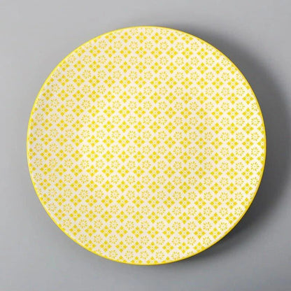 Elegant ceramic plates with vibrant, whimsical prints in a variety of enchanting designs