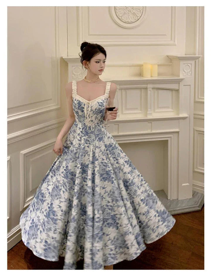 Elegant floral print dress with adjustable straps, A-line silhouette, and high-waisted design for a timeless British fashion look.