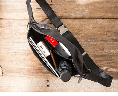 Premium cowhide messenger bag in black, featuring a spacious interior, adjustable shoulder strap, and sleek, minimalist design