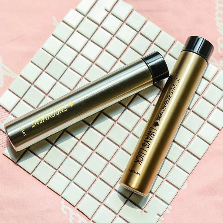 Elegant and slim stainless steel travel thermos in gold colour, with a straight cup design for comfortable one-handed use