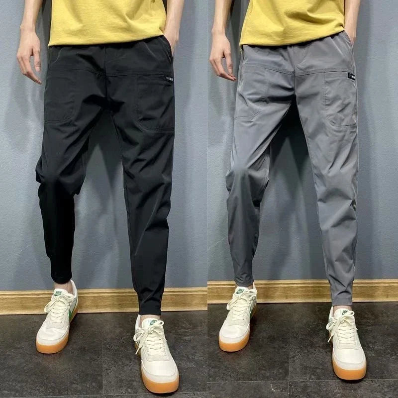 Premium slim-fit drawstring joggers in black and grey, featuring a tailored silhouette and adjustable waistband for a polished, comfortable look.