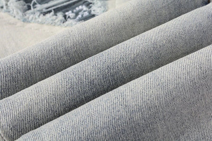 Stylish distressed denim jeans with a skinny, knee-exposed silhouette for a contemporary, high-street fashion look