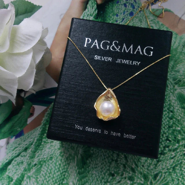 Elegant pearl pendant necklace with sterling silver setting, featuring a modern geometric design