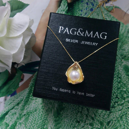 Elegant pearl pendant necklace with sterling silver setting, featuring a modern geometric design