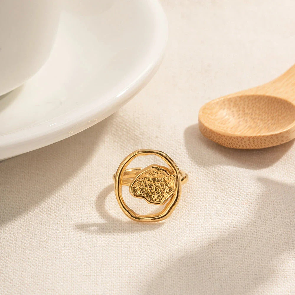 Elegant 18K gold-plated stainless steel ring with intricate hollow-carved design and vintage-inspired charm