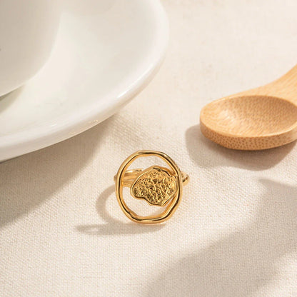 Elegant 18K gold-plated stainless steel ring with intricate hollow-carved design and vintage-inspired charm