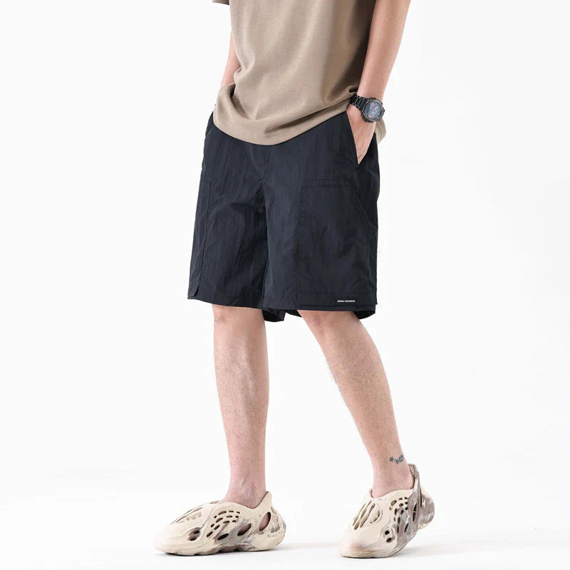 Premium men's quick-drying casual trousers in black, caramel, and sand colours with a relaxed, loose fit