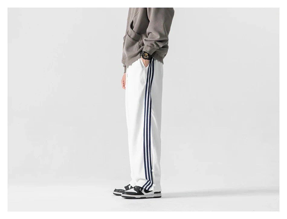 Stylish striped sports trousers in a relaxed, mid-waist design for versatile leisure and athletic wear