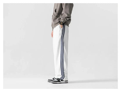 Stylish striped sports trousers in a relaxed, mid-waist design for versatile leisure and athletic wear