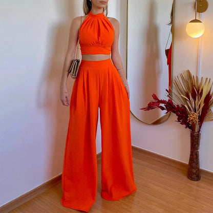 A stylish two-piece set with a halter-neck top and relaxed, high-waisted trousers in a range of sophisticated colours