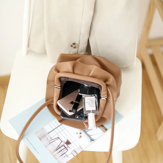 Stylish retro dumpling bag in premium PU material with one-shoulder design and adjustable strap, available in classic British colours