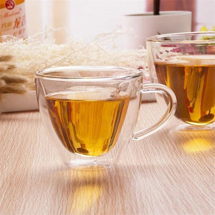 Elegant double heart-shaped ceramic mug in glass, perfect for enjoying hot beverages with a touch of British charm