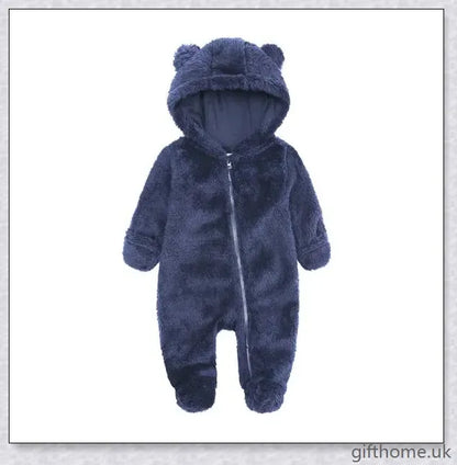 Adorable baby wearing a cosy hooded jumpsuit in blue, pink, or apricot colour