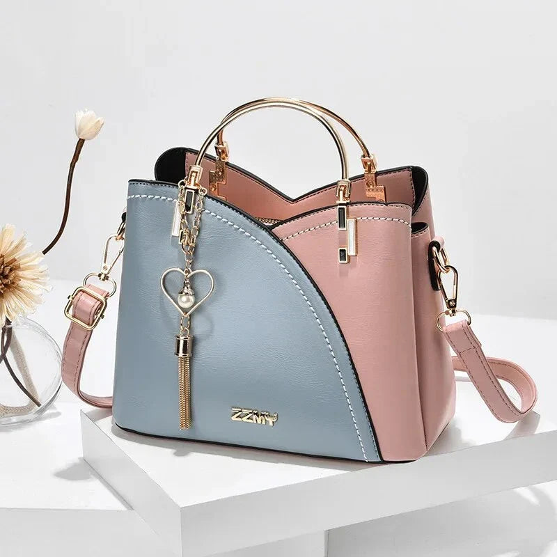 Sophisticated navy blue PU leather bucket crossbody bag with elegant patchwork design and adjustable strap