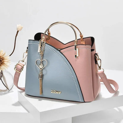 Sophisticated navy blue PU leather bucket crossbody bag with elegant patchwork design and adjustable strap