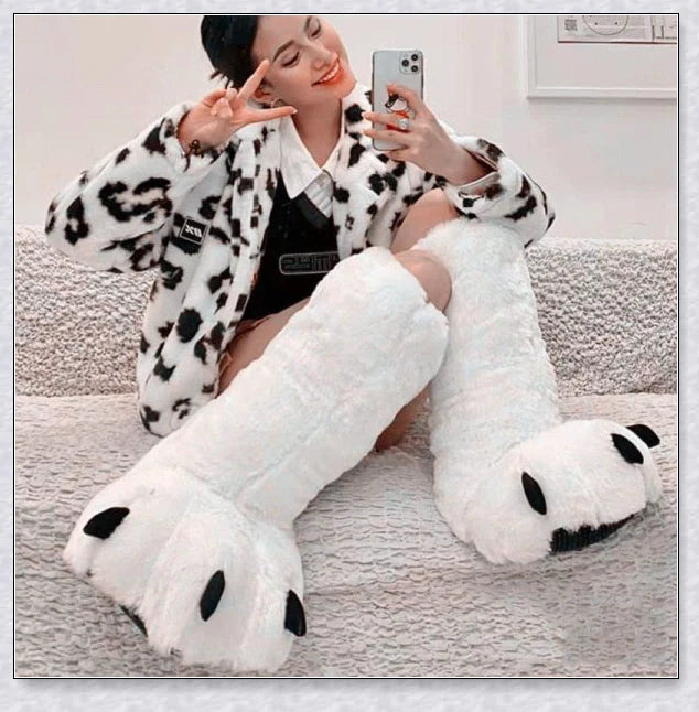 Cosy and whimsical oversized bear paw winter slippers with a plush, fluffy design and non-slip sole for secure indoor wear