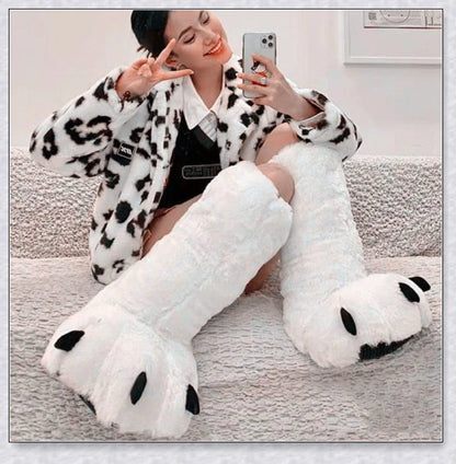 Cosy and whimsical oversized bear paw winter slippers with a plush, fluffy design and non-slip sole for secure indoor wear