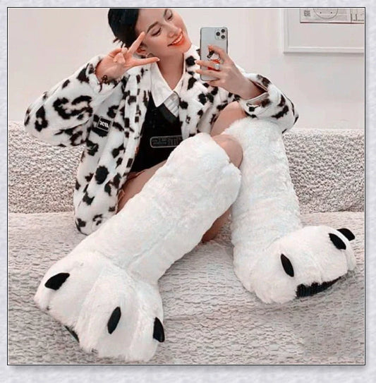 Cosy and whimsical oversized bear paw winter slippers with a plush, fluffy design and non-slip sole for secure indoor wear