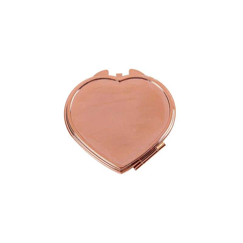 Elegant heart-shaped metal pill box with mirror for organized storage and convenient touch-ups