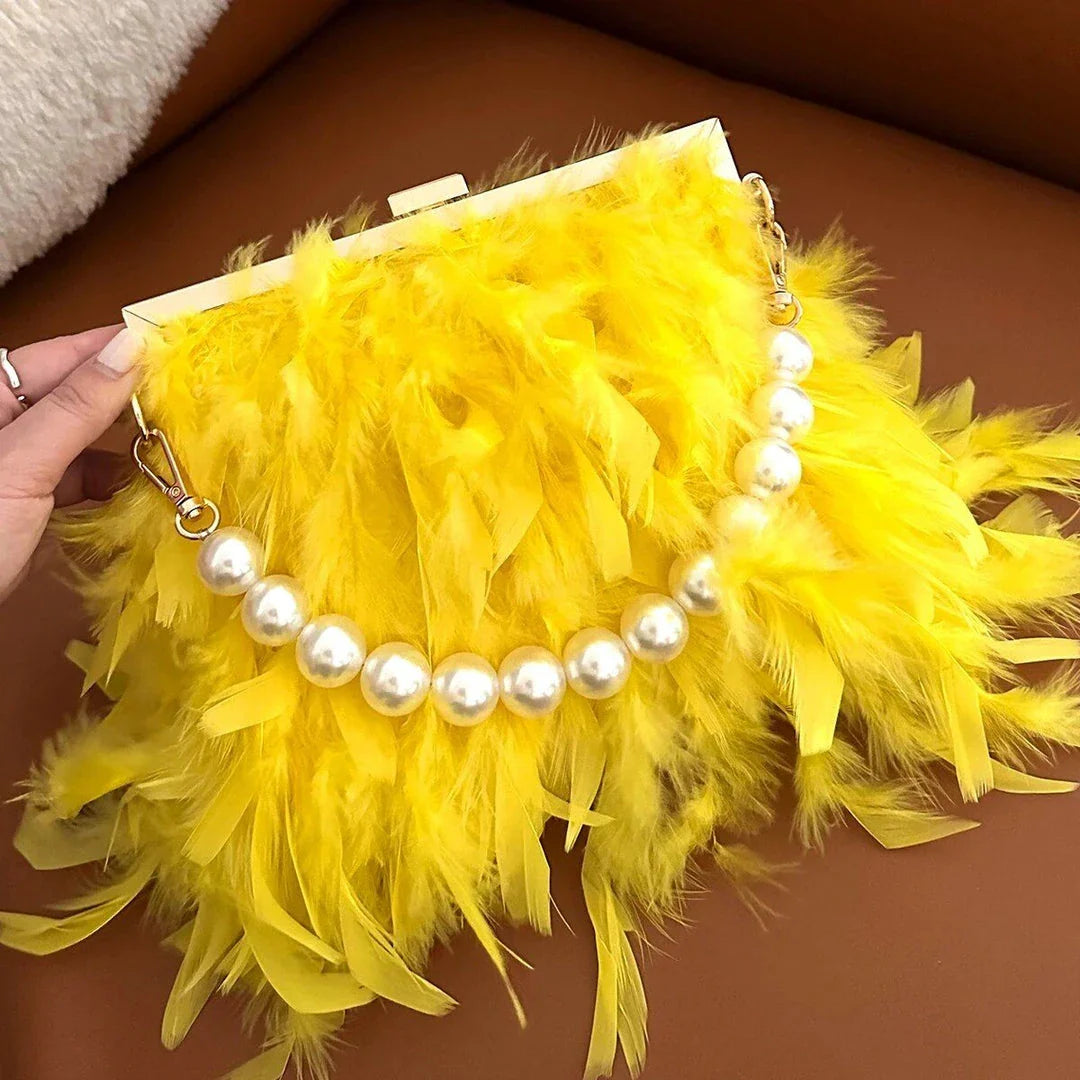 Elegant feather clutch purse with lustrous pearls, metal chains, and a top handle design