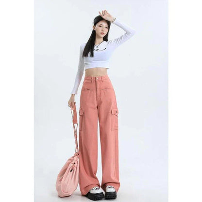 A pair of pink high-waist baggy jeans with a straight-leg design, featuring vintage-inspired details like buttons and faux zippers.