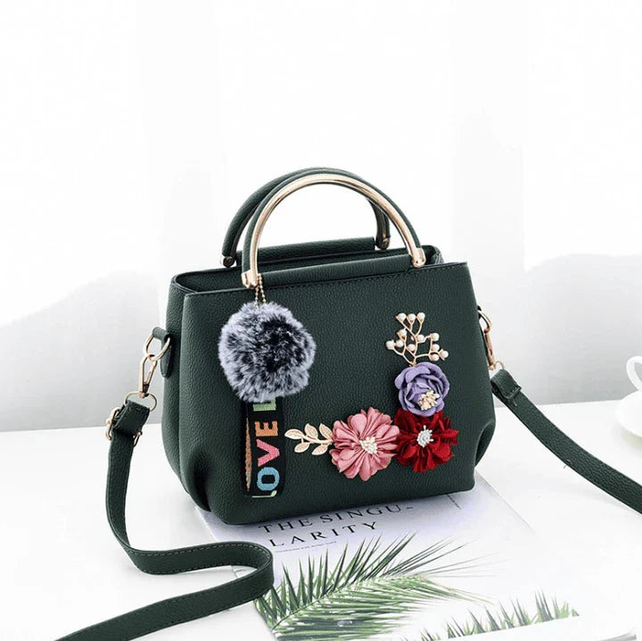Elegant leather tote bag with delicate flower embellishments, perfect for modern British fashion