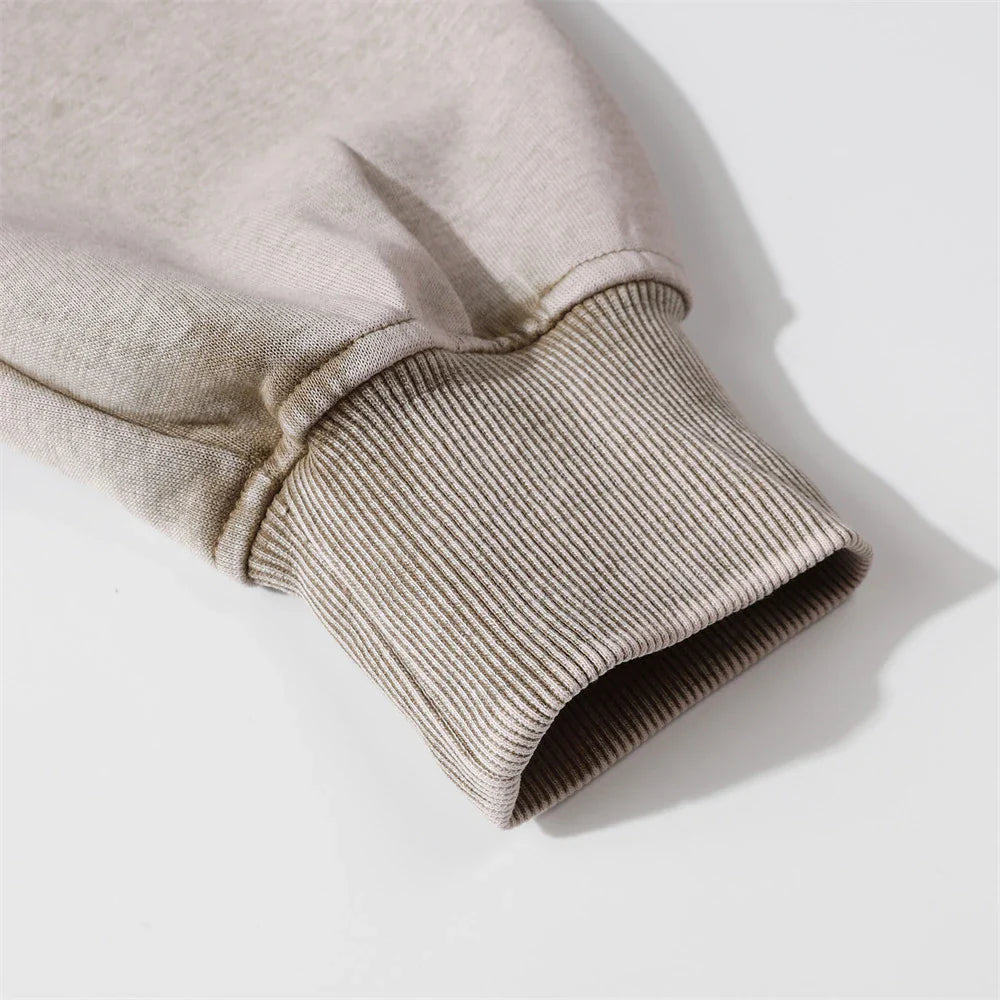 Embroidered cotton hoodie with a letter patch design, available in brown, grey, and black colours and sizes S to XL