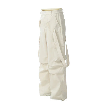 Stylish black pleated overalls with ribbon pockets, a versatile and refined menswear piece.